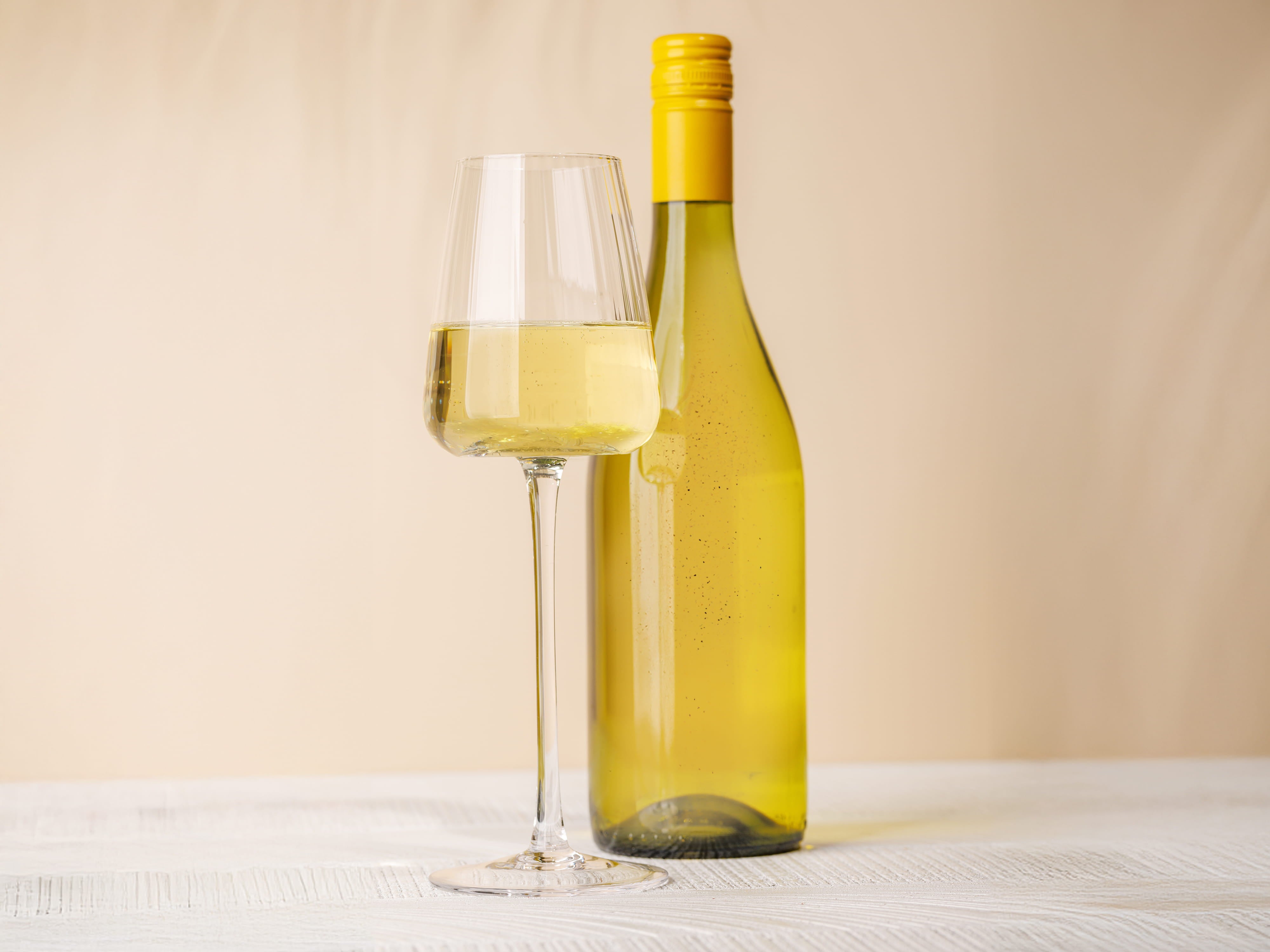 wine bottle with half filled wine glass